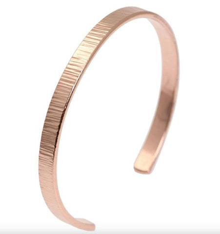 A delicate Chased Copper Cuff Bracelet, adding a touch of elegance to any outfit