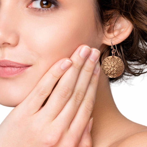 Female Model Wearing Copper Floral Disc Earrings from John S. Brana