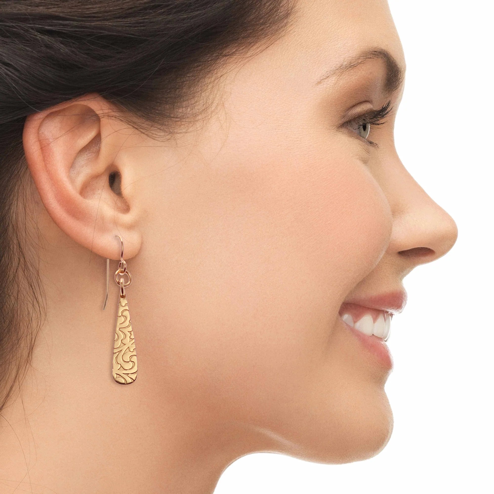 A Woman Smiling Wearing Damask Embossed Mini Bronze Teardrop Earrings