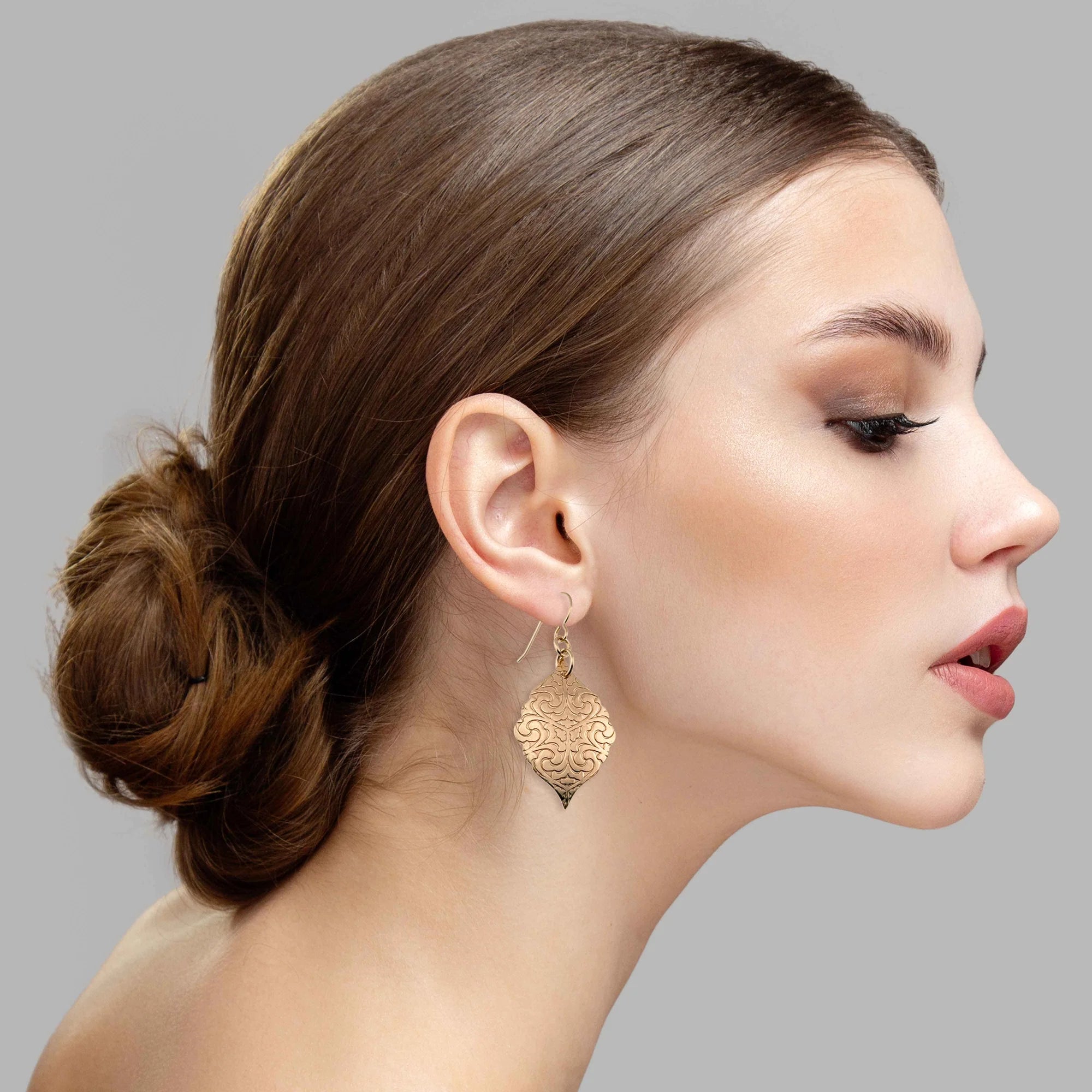 An Elegant Woman Wearing  Damask Embossed Bronze Moroccan Drop Earrings