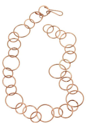 A close-up of a Hammered Copper Chain Necklace with circular links, showcasing its intricate design and metallic sheen