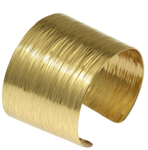 A Nu Gold Brass cuff bracelet with intricate bark texture, adding elegance and sophistication to any outfit