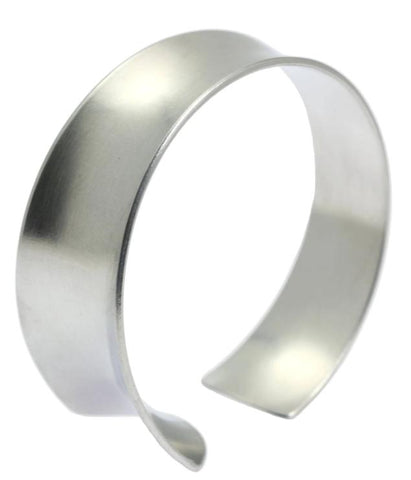 A sleek brushed aluminum anticlastic bangle with an elegant curved design, perfect for adding a touch of sophistication to any outfit