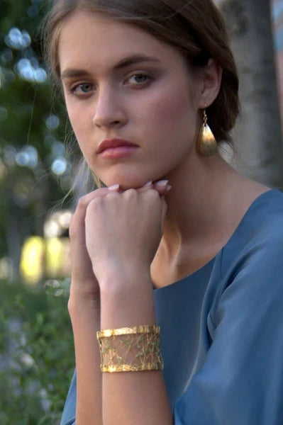 Female Model Wearing Nu Gold Brass Earrings and Cuff from John S. Brana