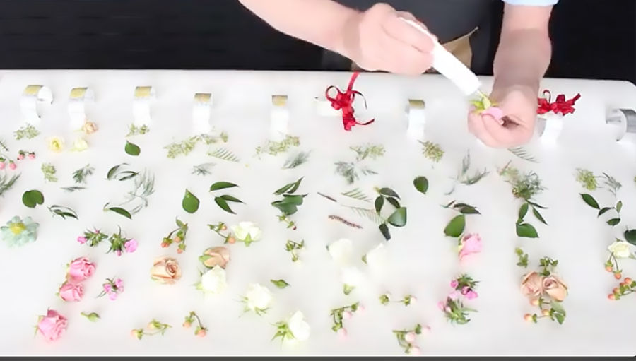 A florist putting glue on corsage pieces