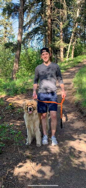 boy hiking with golden retriever