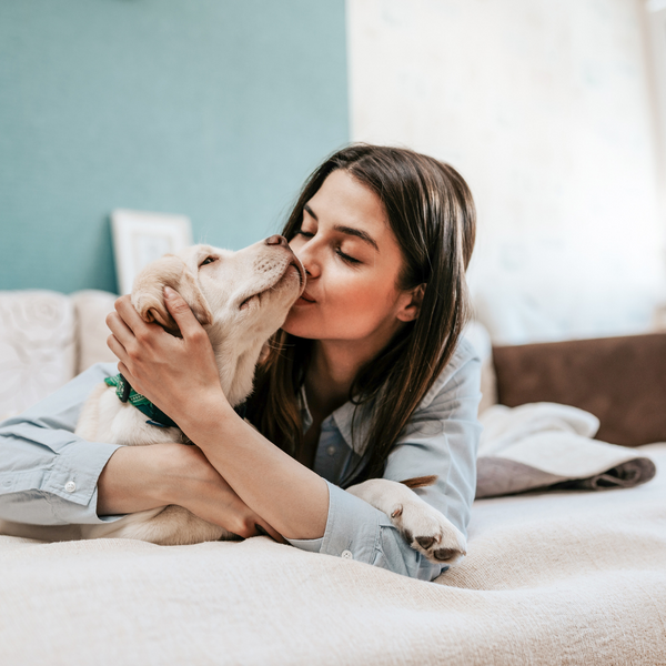 girl kissing dog 