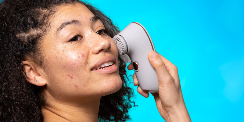 Model holding BareFaced3 to her cheek