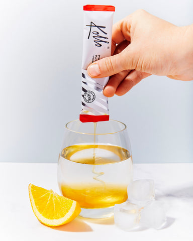 Kollo Health Marine Collagen sachet being squeezed in to a glass of water
