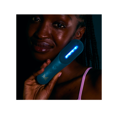 Model holding MAGNITONE XO Lights Out LED Cleansing brush with blue led light 