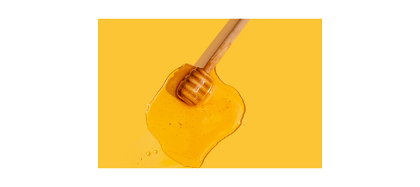 Stock image of honey on a yellow background