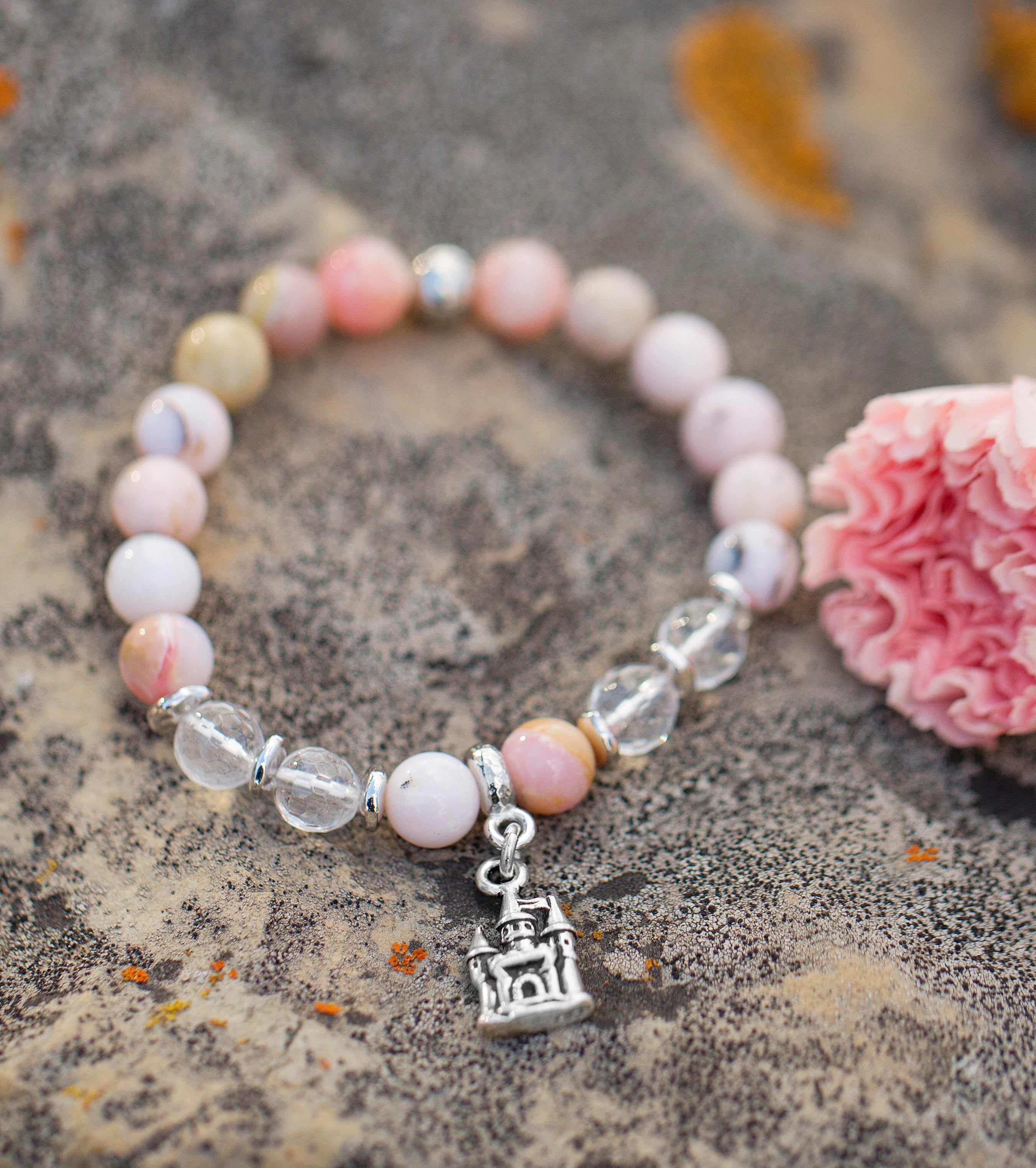 silver castle charm bracelet on pink opla