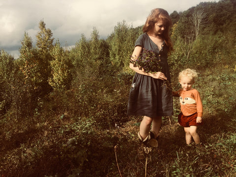 Mom and baby wildcrafting medicinal plants