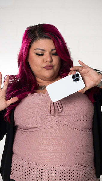 Portrait of woman holding a white iPhone case