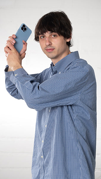 Portrait of man holding an iPhone case like a sword