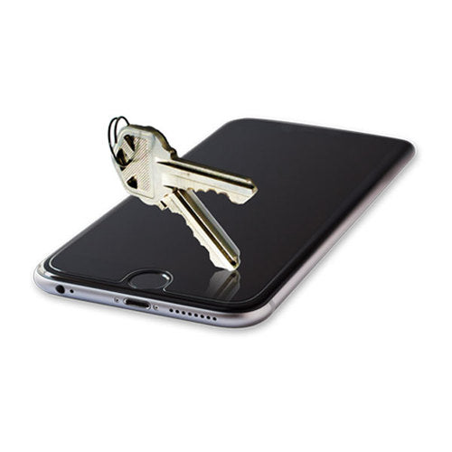 A tempered glass screen protector on an iPhone providing scratch protection from keys.