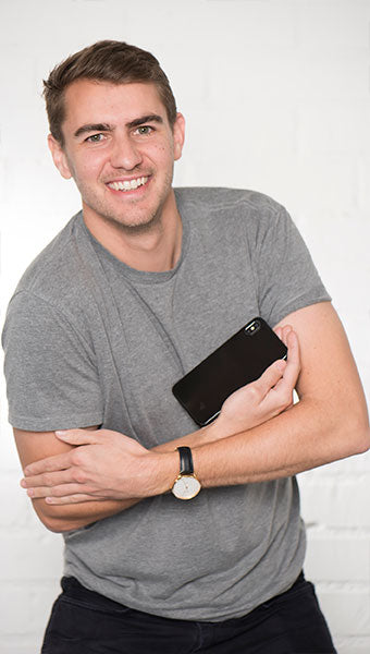 Portrait of man in front of exposed brick wall