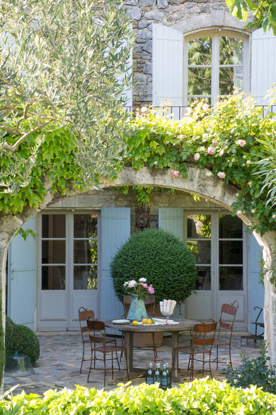 Antique French metal iron garden furniture in courtyard French garden