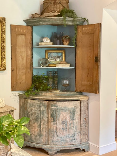 Antique collectibles in corner cabinet