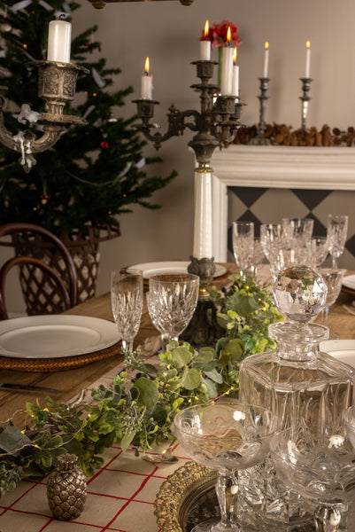 Holiday table setting with garland and candelabra