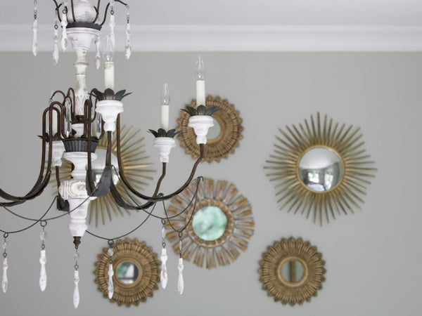 Sunburst mirror gallery wall with chandelier lustre white and grey interior