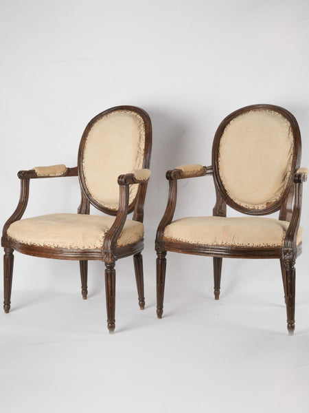 Pair of Louis XVI walnut cabriolet armchairs