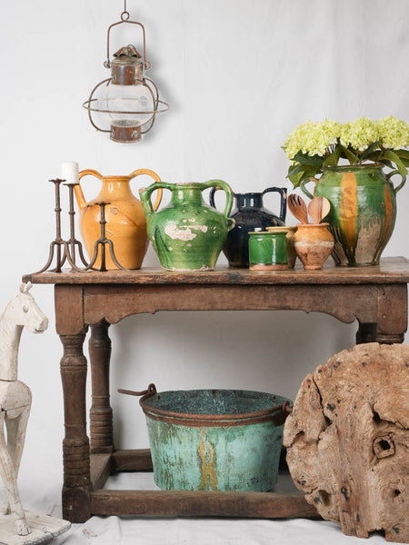 Vignette of antique French green and ocher pottery