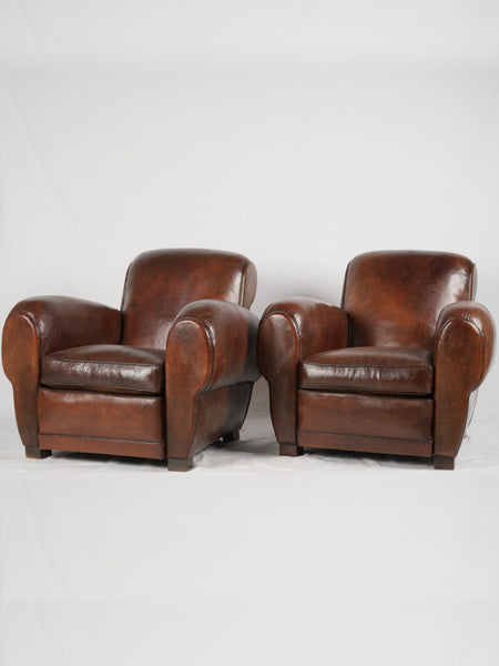 Pair of scroll back or gang box French leather club chairs
