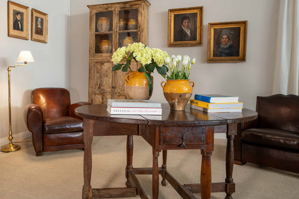 Antique French confit pots with hydrangeas and tulips