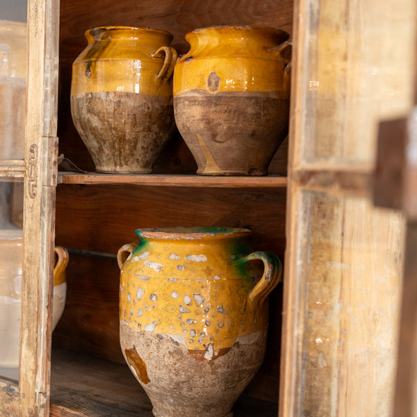 Details of antique French confit pots ochre and green glaze