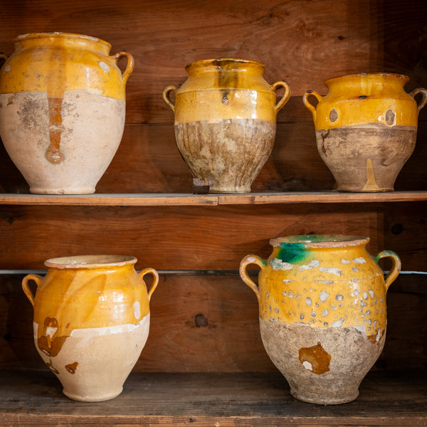 Collection of antique French confit pots open shelves