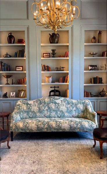 Antique pottery and books on open shelves