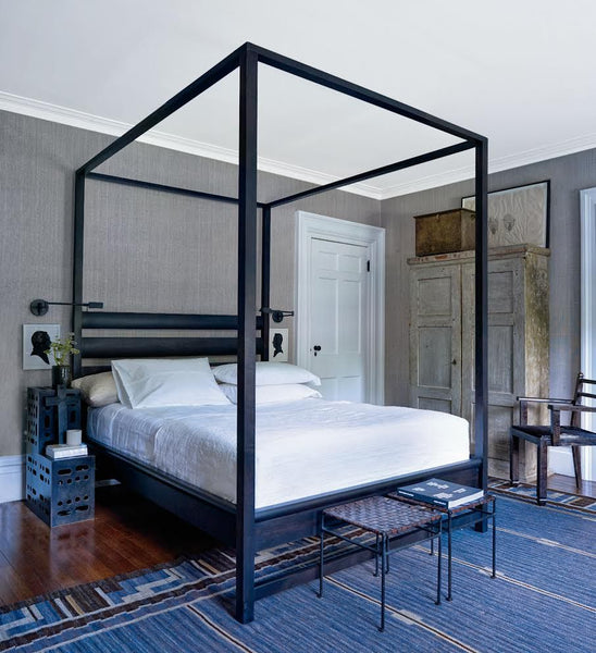 Bedroom with four poster bed and armoire