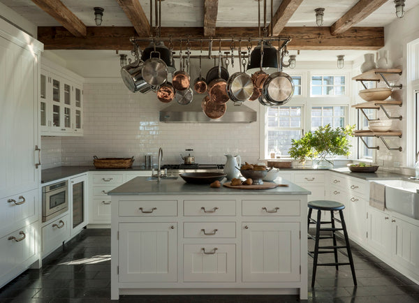 Modern farmhouse kitchen with copper pots and vintage stool - Mark Cunningham