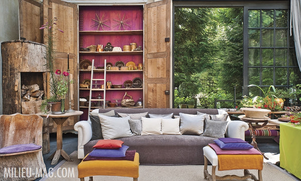 Pops of colour in a fun living room looking out to garden - Walda Pairon