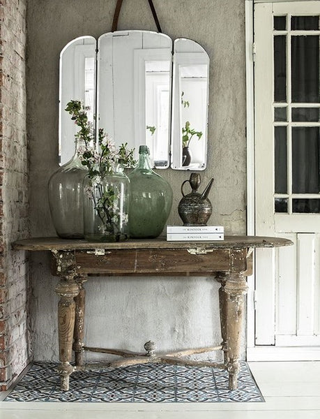 vintage demijohns on french winemakers table rustic farmhouse entryway