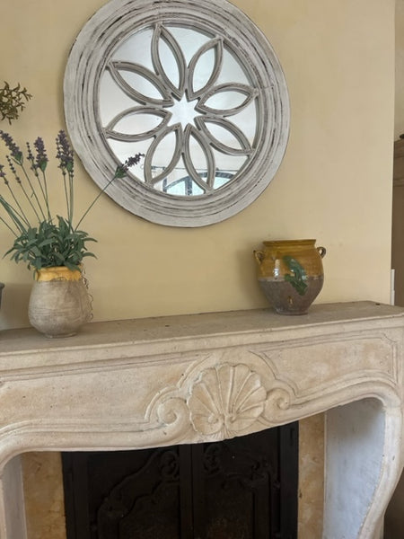 Antique French confit pot on stone fireplace