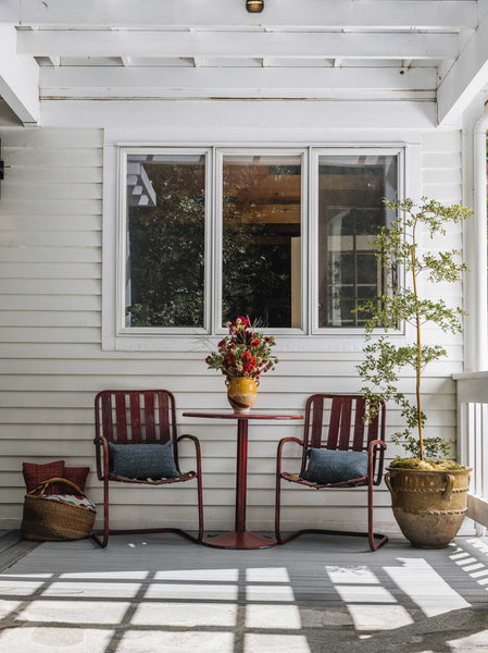 Weatherboard veranda with confit pot as vase