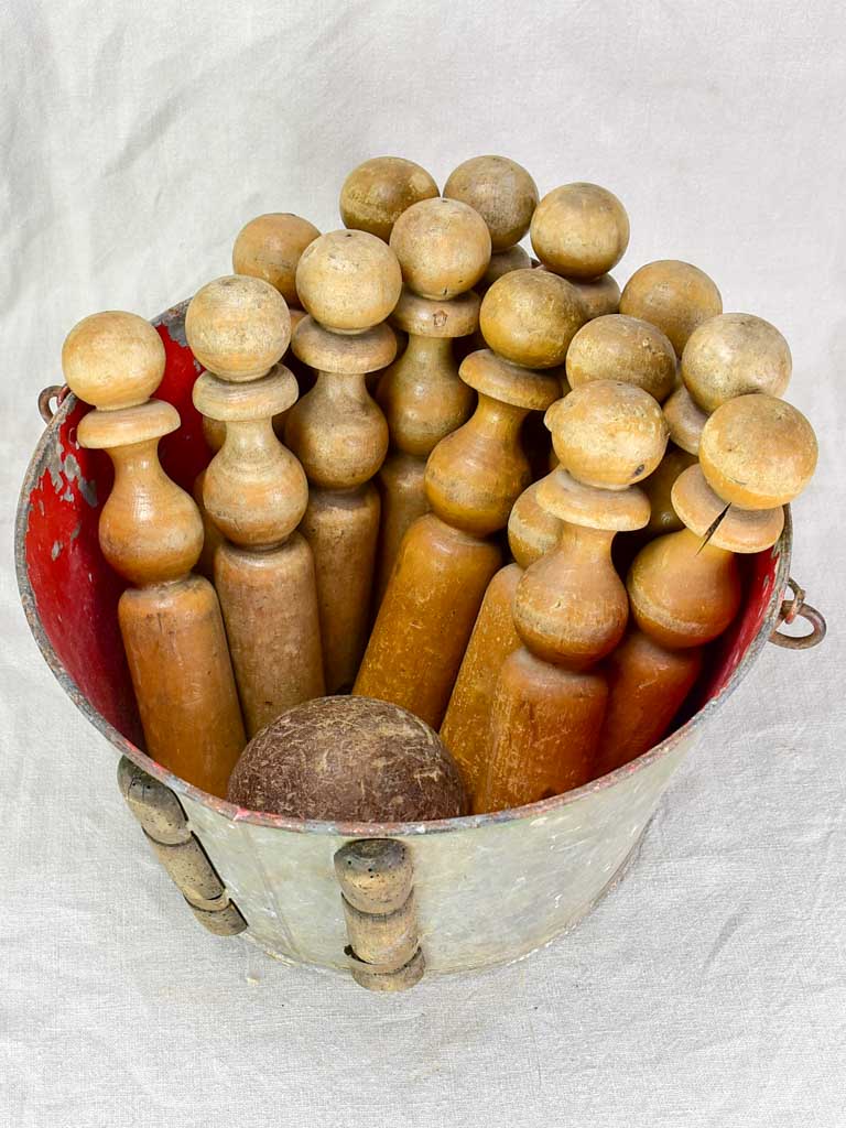 antique skittles game with wooden pins and iron bumbers