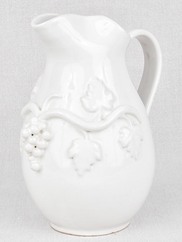 Artisan made terracotta pitcher with grape motif 9"
