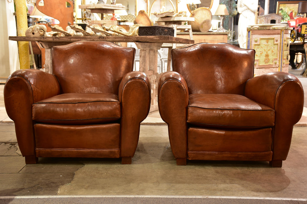 Pair of large moustache back French leather club chairs