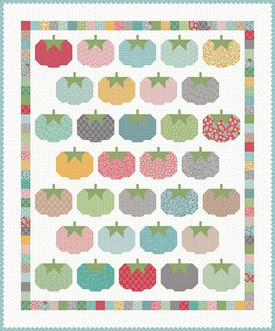 patchwork quilt featuring tomato pincushion blocks on a white background