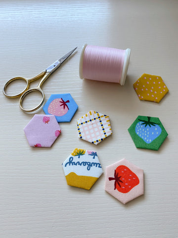 fabric covered hexagon shapes with scissors and thread