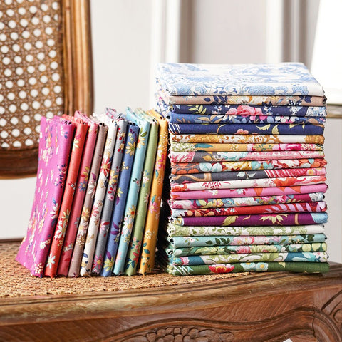 a stack of folded chintz floral fabric 