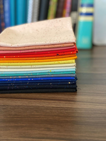 stack of ruby star society speckled fabric in rainbow order