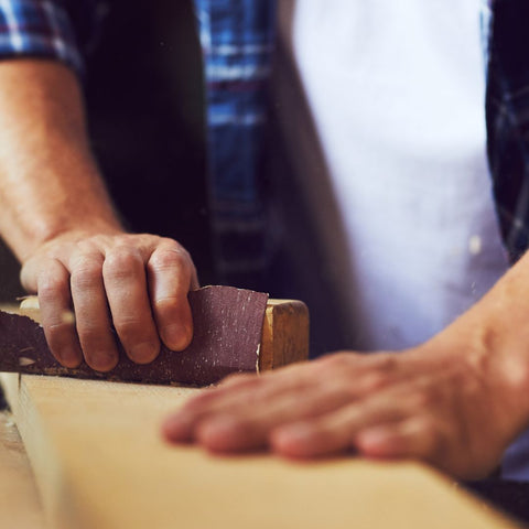 img of someone using sandpaper 