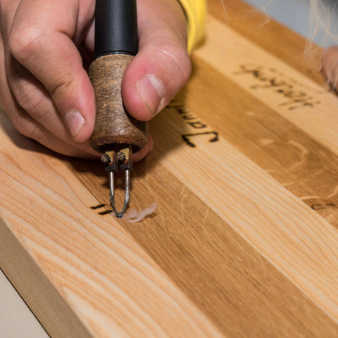 img of someone using a woodburning pen