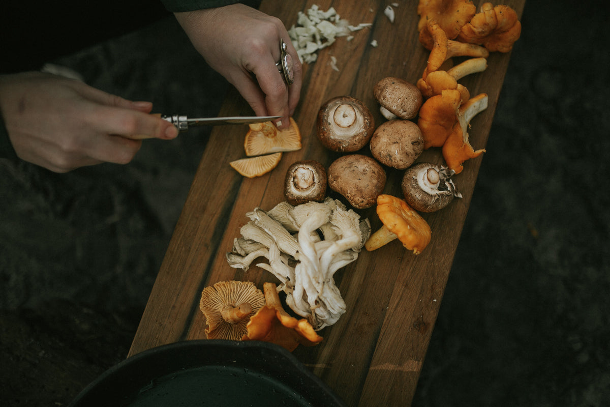 woman slicing mushrooms outdoors with Opinel Knife