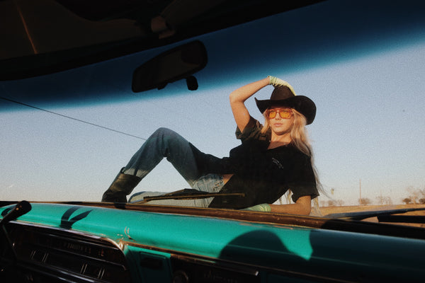 woman laying on truck hood