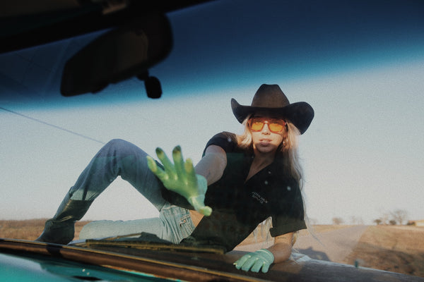 woman laying on truck hood